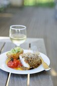 Fish with a spicy crust and a side of vegetables (France)