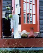Shoes, boots and branch of apples in boot-shaped vase put out on terrace for St. Nicolas