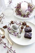 Small wreaths of callicarpa berries with candle and slices of gingerbread