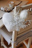 Christmas decorations hanging on chair back