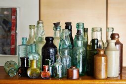 Collection of vintage bottles on wooden surface