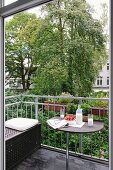 Milk, strawberries, eyeglasses and newspaper on balcony table