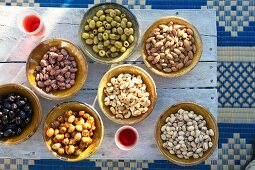 Dishes of Oriental nibbles on rustic wooden table