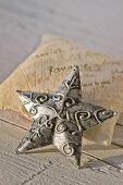 Decorative, metal star on scented sachet