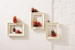 Russian dolls in white picture frames as Christmas decorations