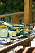 Glasses of Lemonade and Salad in a Glass Bowl on Outdoor Patio Table