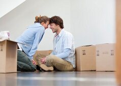 Couple sitting with cardboard boxes