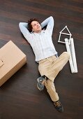 Man laying on floor with boxes