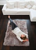 Smiling woman laying on rug