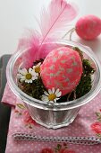 Easter arrangement with Easter egg, moss and feather