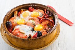 Tomato bake with peppers and fried eggs
