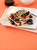 Crêpes filled with berries and chocolate sauce