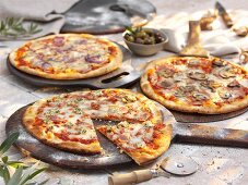 Three different stone oven pizzas