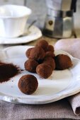 Handmade chocolate truffles and an espresso