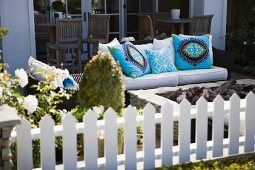 Patio furniture with brightly colored throw pillows