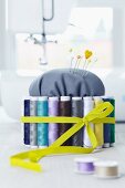 DIY pin cushion with spools of thread and elastic band