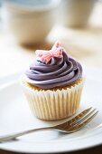 A cupcake decorated with a butterfly