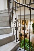 Detail wooden staircase with wrought iron railing