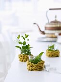 Glasses decorated with leaves and with roughly knitted cuffs as protection against hot tea