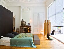 Spacious bedroom with louver blinds on glass wall and stucco ceiling