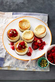 Miniature goat's cheese and pistachio cheesecakes with raspberries and rosewater