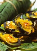 Mussels with saffron and white wine sauce, served in banana leaves