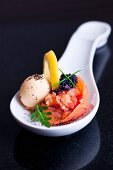 Smoked salmon with lumpfish caviar, egg and a slice of lemon on a spoon