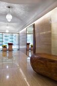 Long marble hallway with double glass doors at end