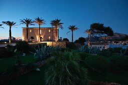 Front exterior Mediterranean style home at dusk