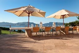 Umbrellas above dining table on patio