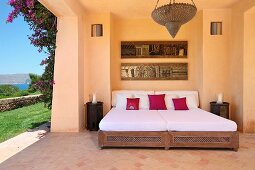 Open air room in Mediterranean style home with outdoor bed