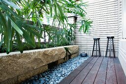 Stools on small patio along house