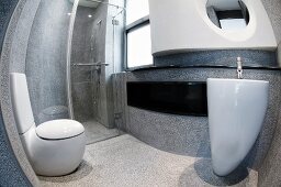 View through a fish eye lens of a futuristic, concrete bathroom with white designer bathroom fixtures