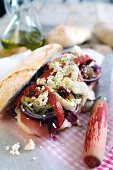 Ciabatta sandwich filled with Parma ham, red onions, sweet bell peppers, artichokes, sun dried tomatoes and feta cheese