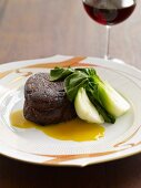 Beef Fillet with Baby Bok Choy; Glass of Red Wine