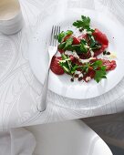 Plate of beef carpaccio on table