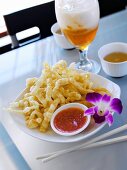 Crispy, Deep-fried Noodles with Chili Dipping Sauce and Orchid Garnish