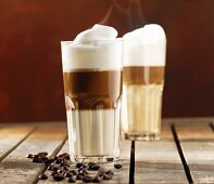 Two glasses of steaming latte macchiato