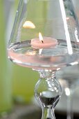 Lit tealight in glass candlestick