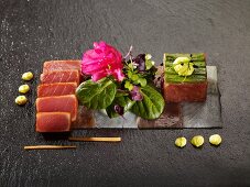 Tuna tataki and tartar arrange on slices of sea bass and tuna