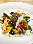 Fried cod fillet with spring vegetables, basil and lime oil