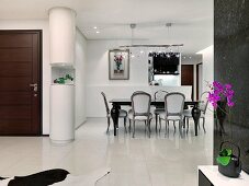 Post modern chairs and table on white tile floor in a modern living room