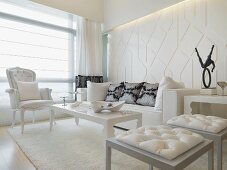 Living room with post modern stools in front of a coffee table and white neo-baroque armchair