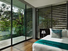 Floor to ceiling windows in modern bedroom