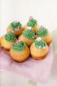 Lime cupcakes decorated with green chocolate cream and sugar sprinkles