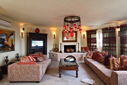 Octagonal living room with open fireplace, sofas, coffee table and TV (Villa Octavius, Lefkas, Greece)