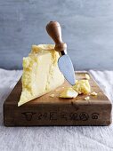 Parmigiano (a piece of Parmesan cheese on a chopping board)