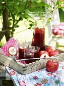 Apple punch on a table in a summery garden