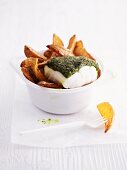 Cod with a herb crust and potato wedges