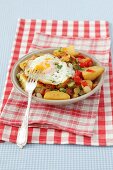 Fried potatoes with pancetta, peppers, gherkins and a fried egg